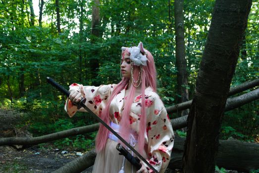 A woman in a kimono with pink hair and a katana poses in a serene forest.