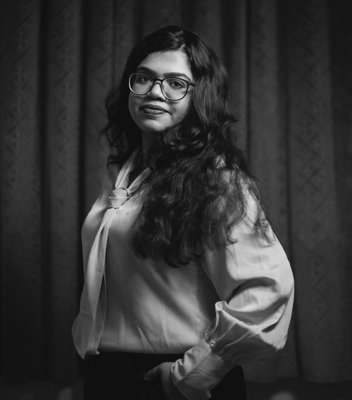 Free Black and white portrait of a woman with glasses in a blouse, exuding elegance. Stock Photo