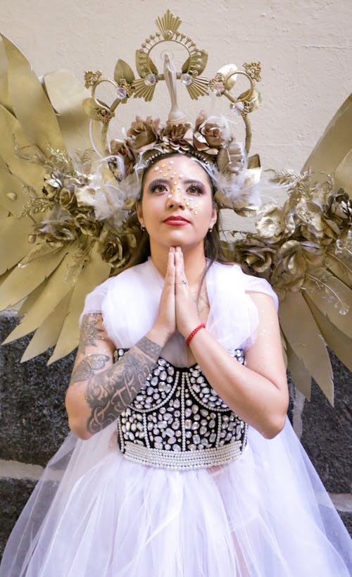 Model in a White Chiffon Dress and Golden Angel Wings with a Halo Crown Free Stock Photo Model in a White Chiffon Dress and Golden Angel Wings with a Halo Crown Free Stock Photo