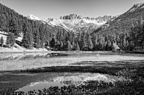 Black and white photo of mountains and lake