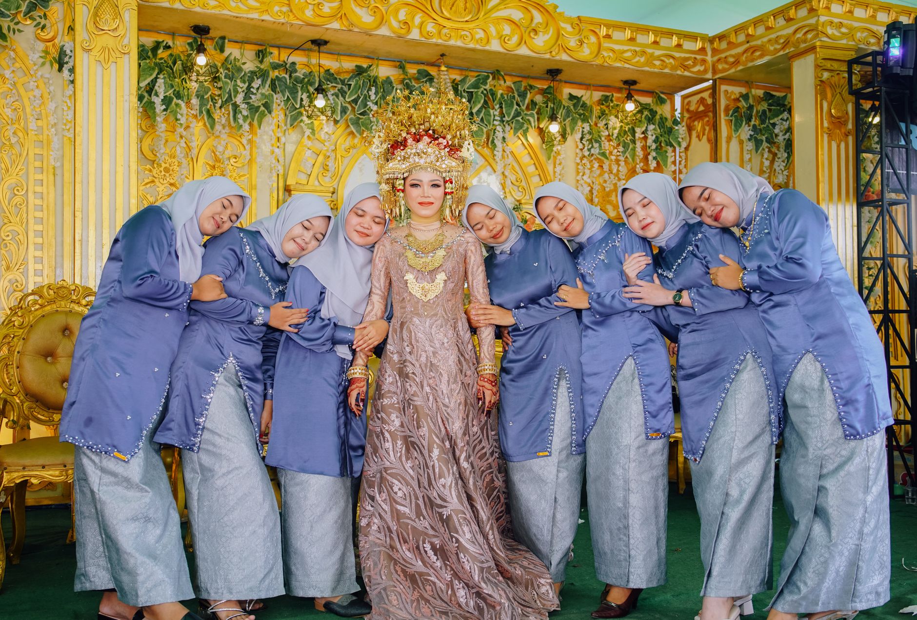 A beautiful bride with her bridesmaids in traditional Indonesian wedding attire, celebrating joyfully.