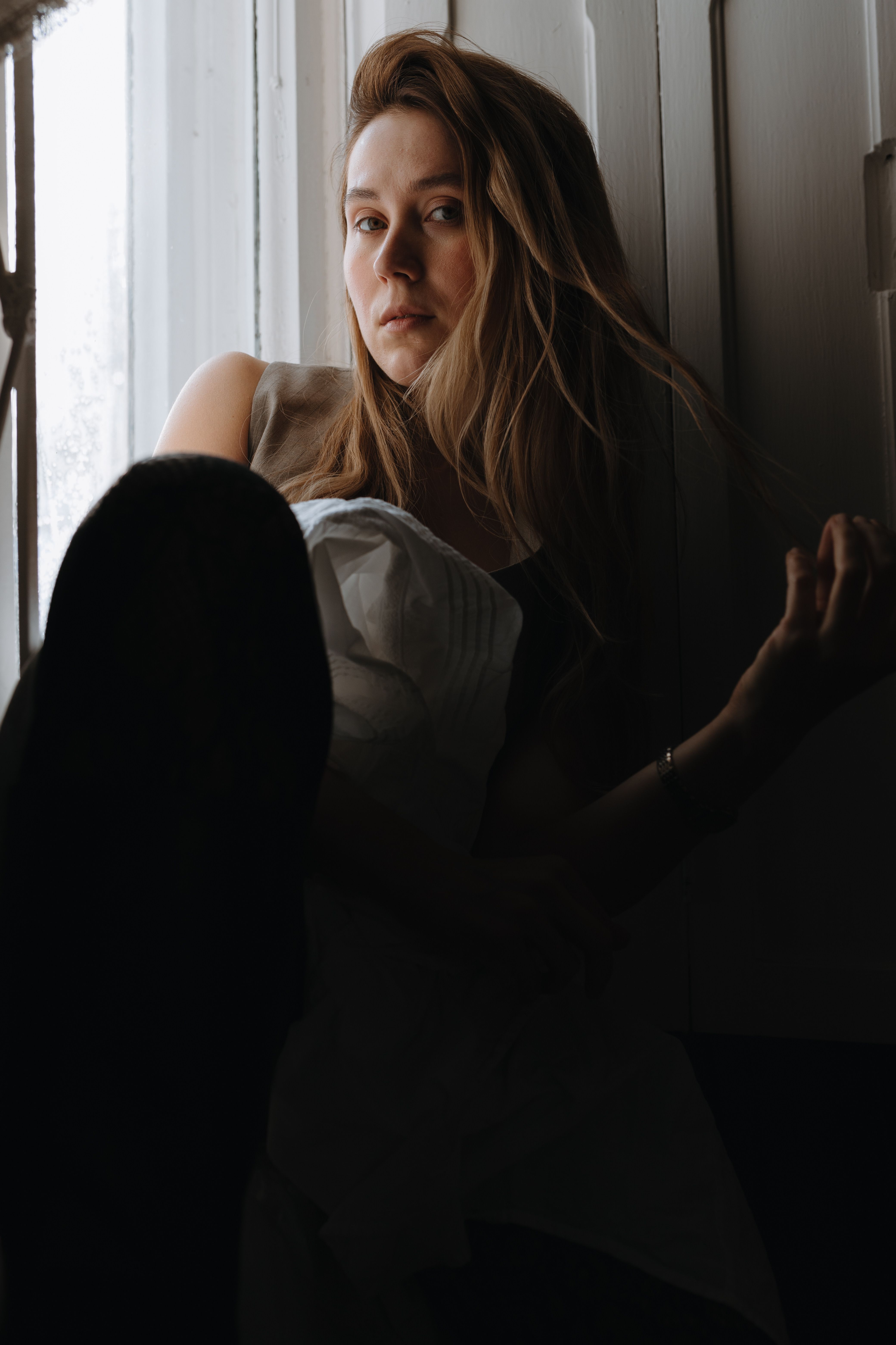 Young Woman Sitting by the Window · Free Stock Photo