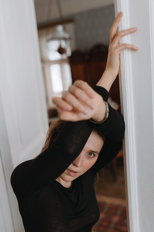 Woman Standing with Arms Raised