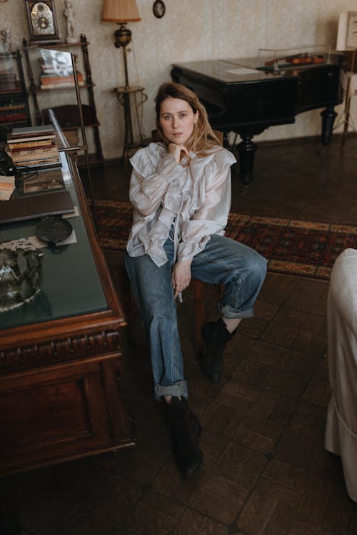 Woman Sitting and Posing in Vintage Room