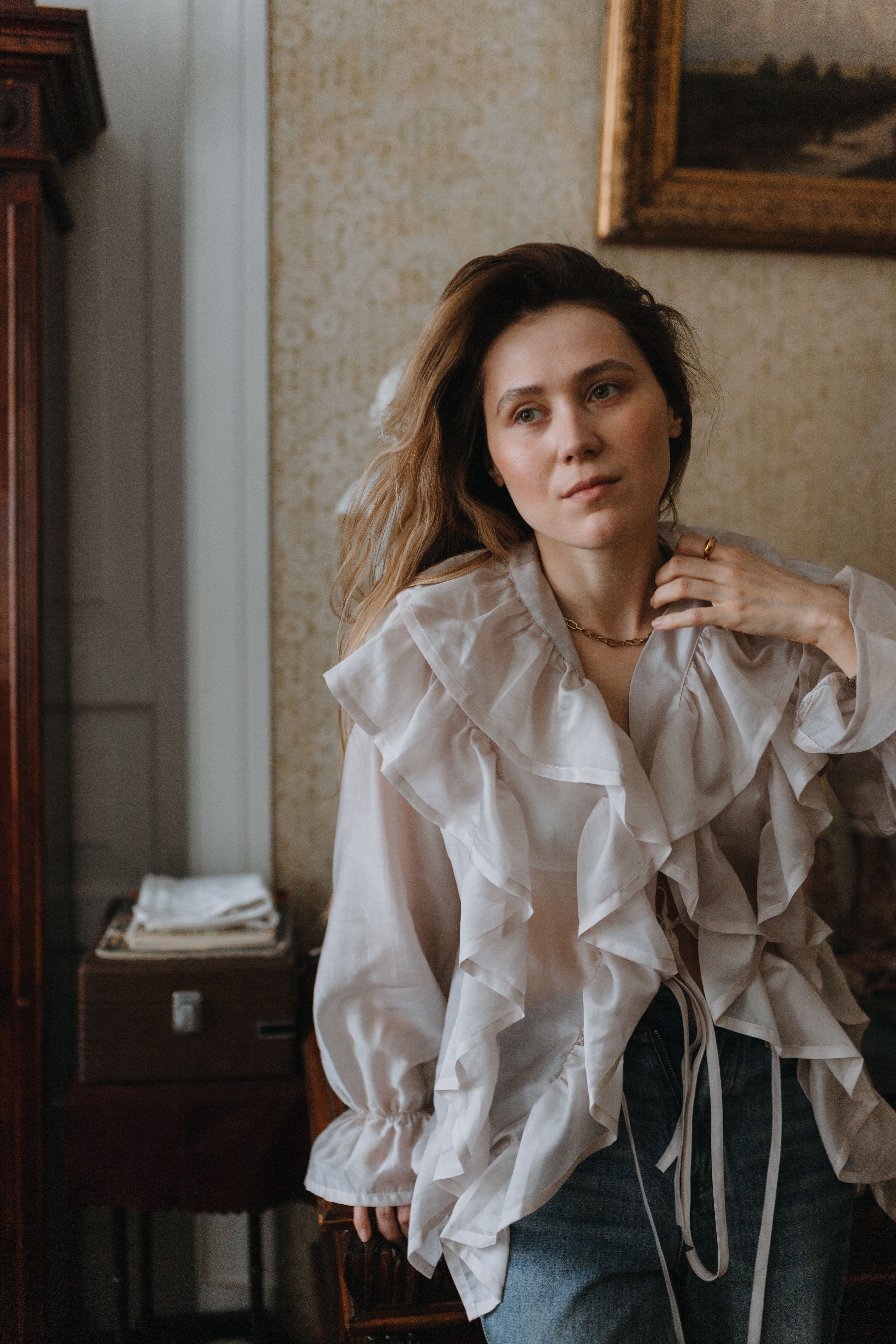 Woman in ruffled blouse and jeans