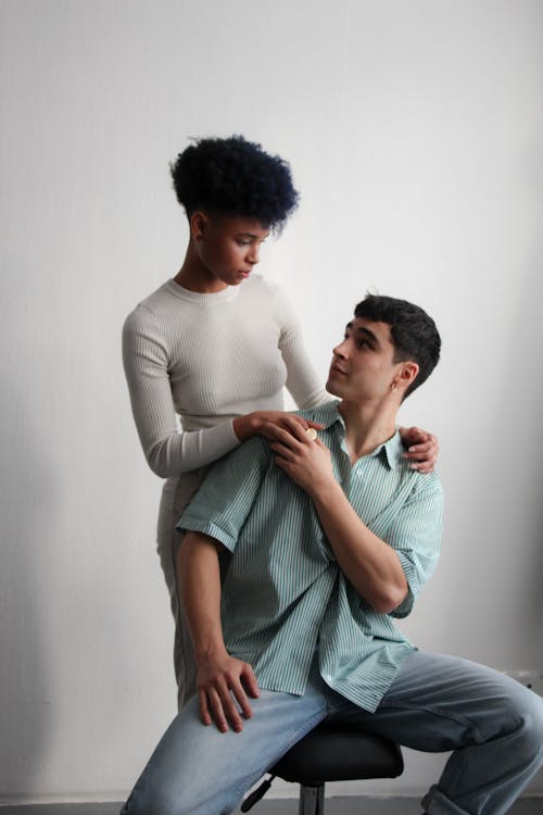 Studio Shot of a Young Man and Woman in Fashionable Clothing 