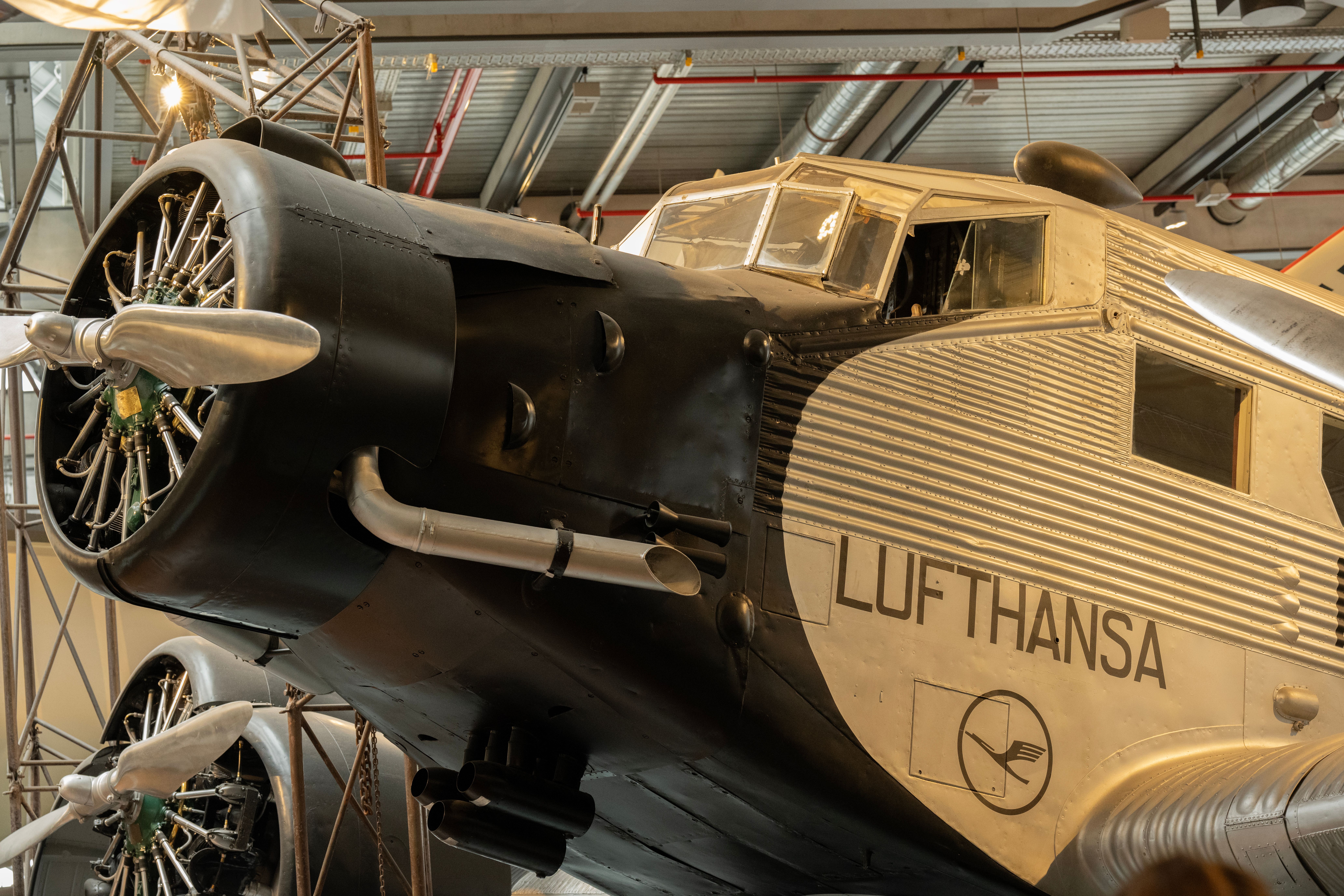 Close-up of a classic Junkers JU 52 aircraft at an aviation museum, showcasing its historic design.