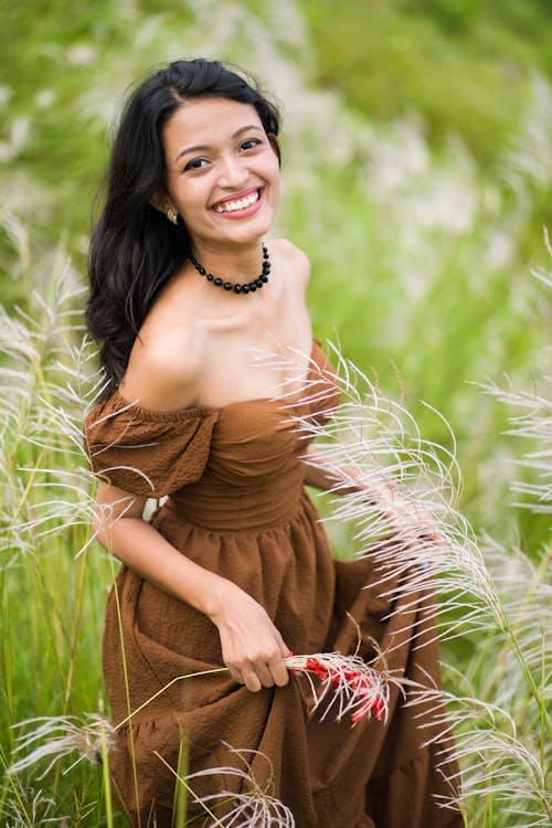 Smiling Woman in Dress on Meadow