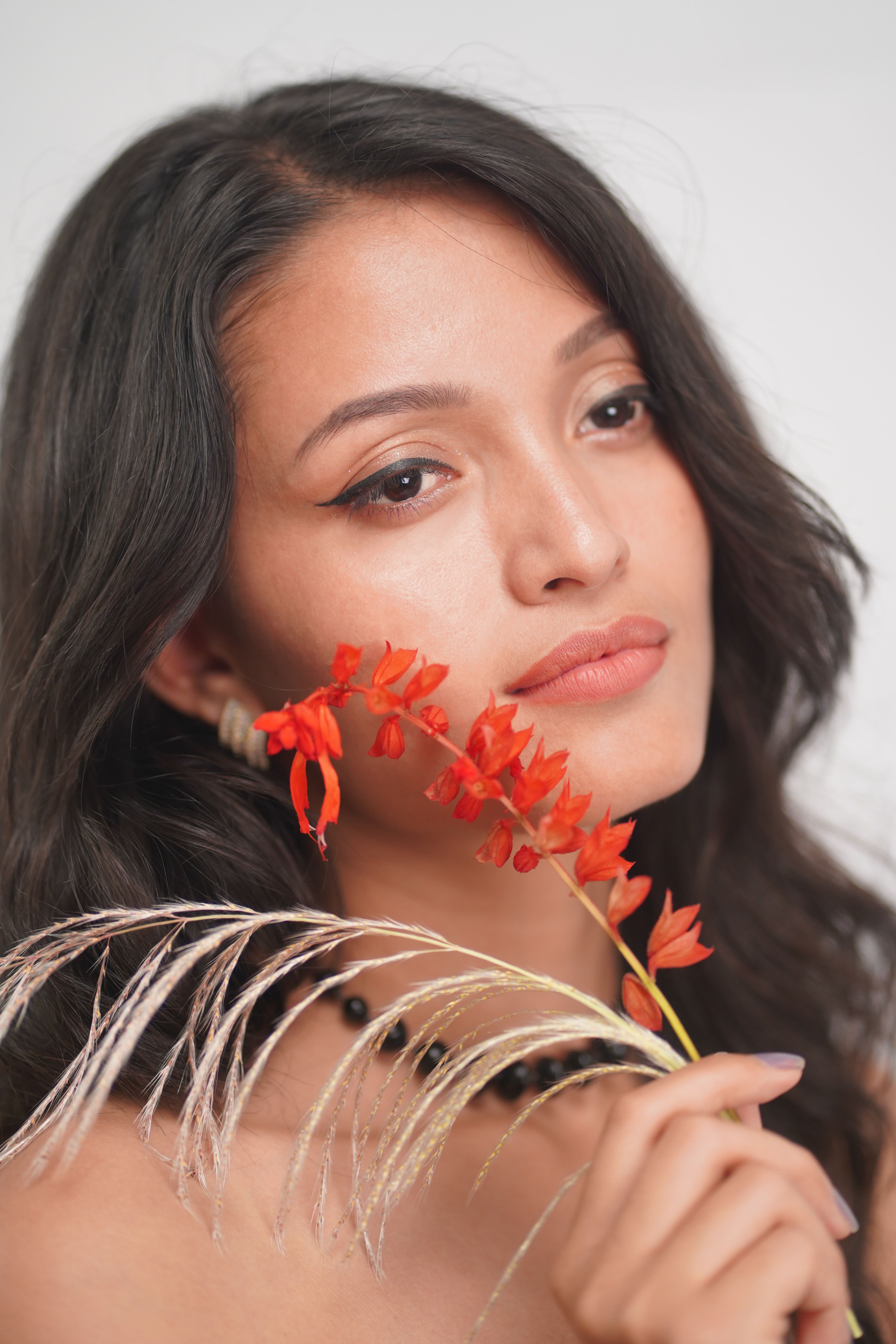 A woman with long hair holding a flower · Free Stock Photo