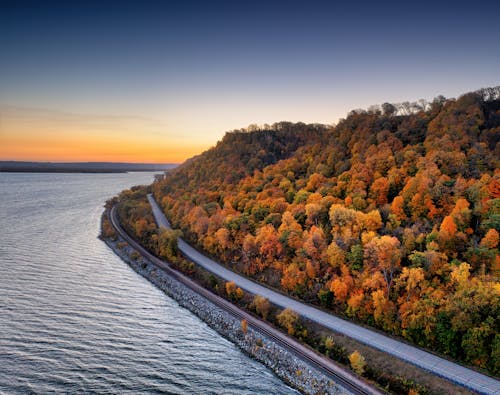 A scenic view of the river and trees in fall