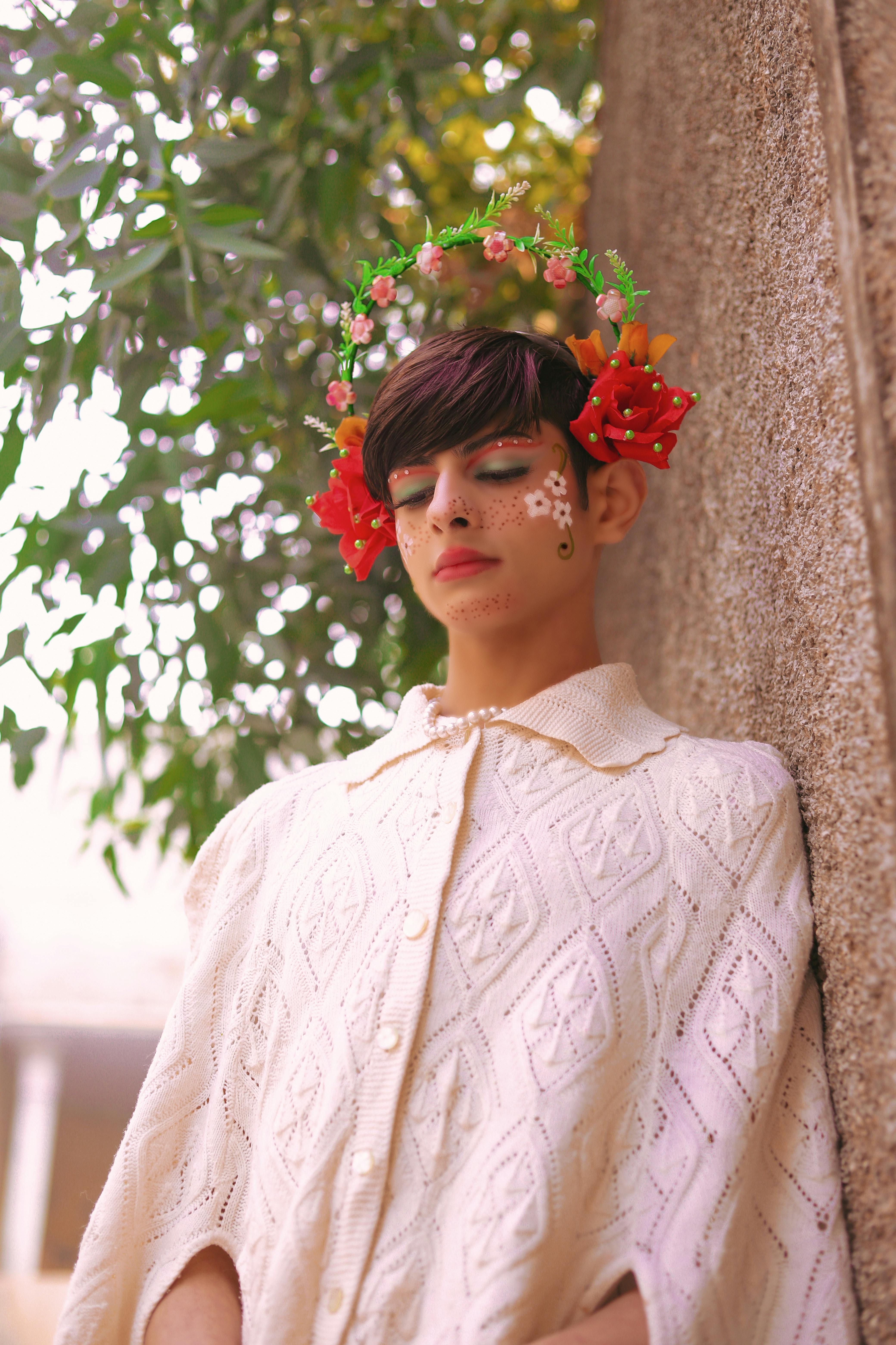 photo of a young person with artistic makeup and flowers in hair