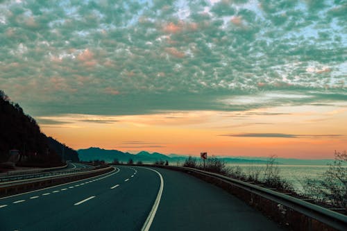 Empty Asphalt Road on the Coast at Sunset