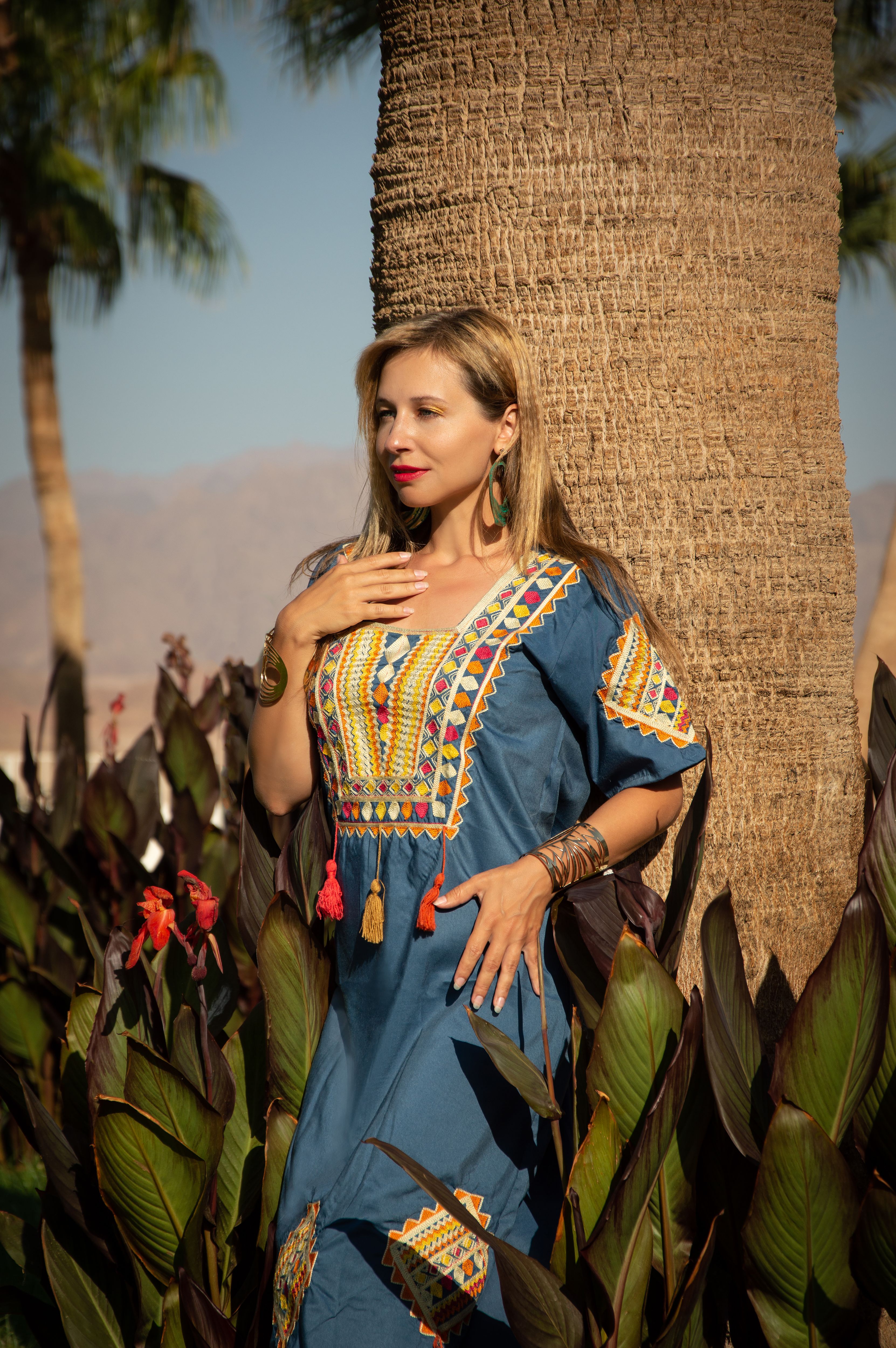 Female Model Wearing a Traditional Dress Posing in Front of a Palm Tree ...