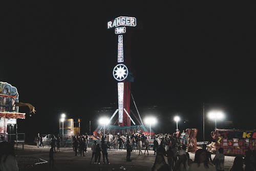 Crowd at Theme Park with Large Illuminated Carousel