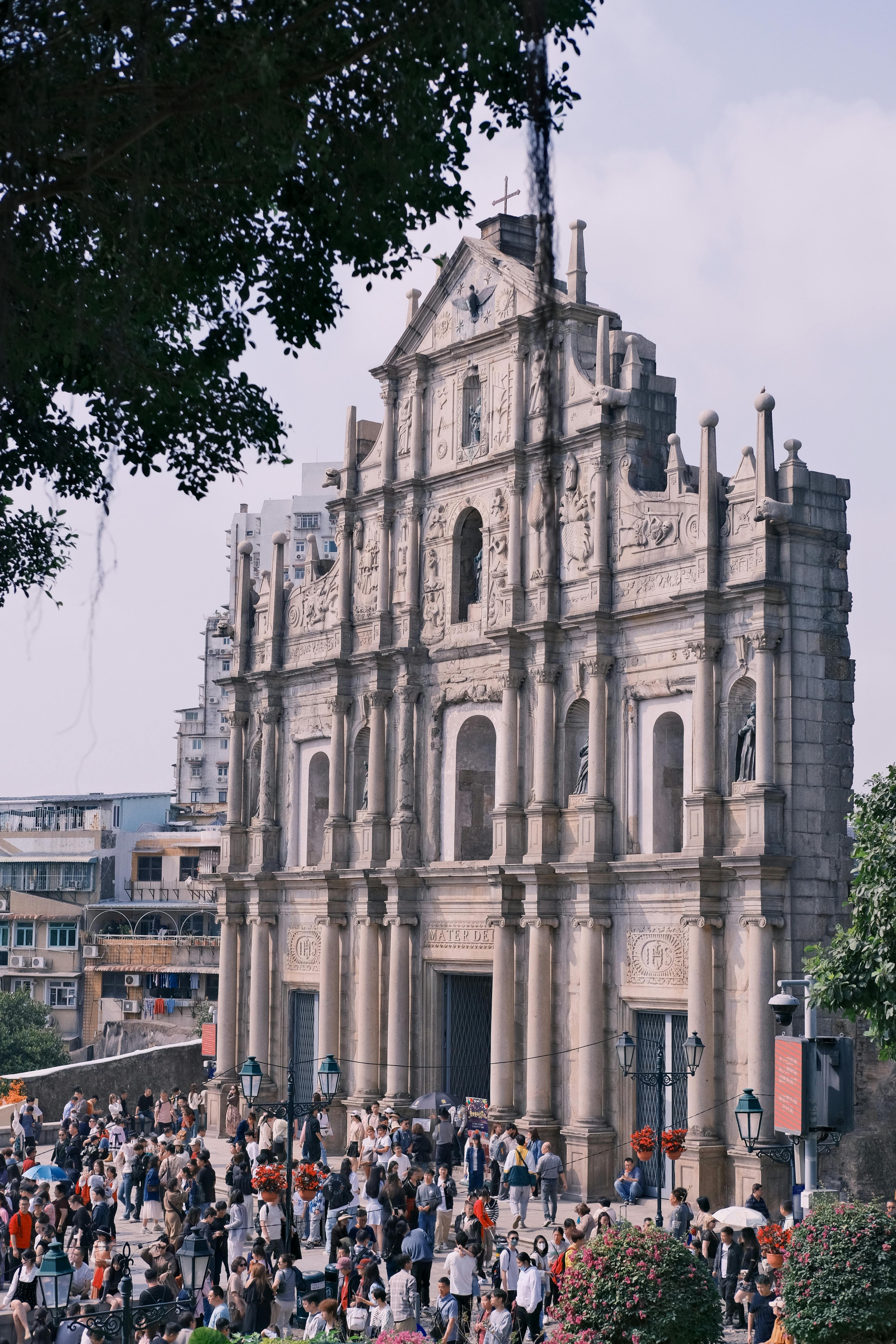 Vibrant scene of crowds visiting the iconic Ruins of St. Paul's in Macau, China.