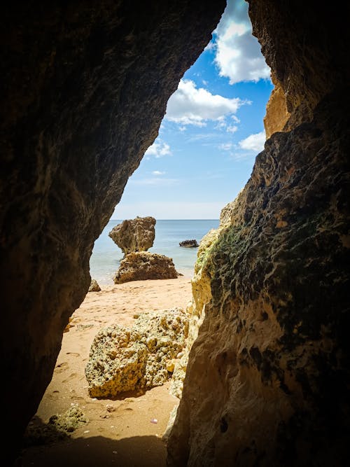 Rock Cave Going Out to a Sandy Beach