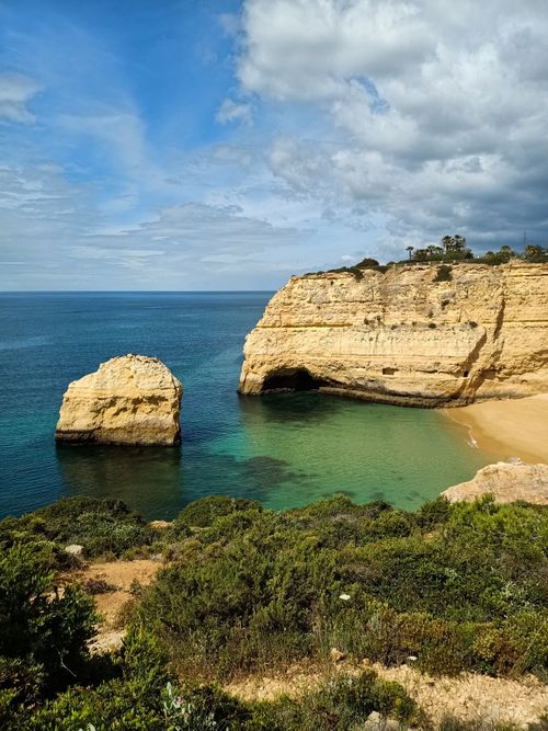 Free Stunning cliffs and beach in Algarve, Portugal, showcasing natural beauty and a clear blue ocean. Stock Photo