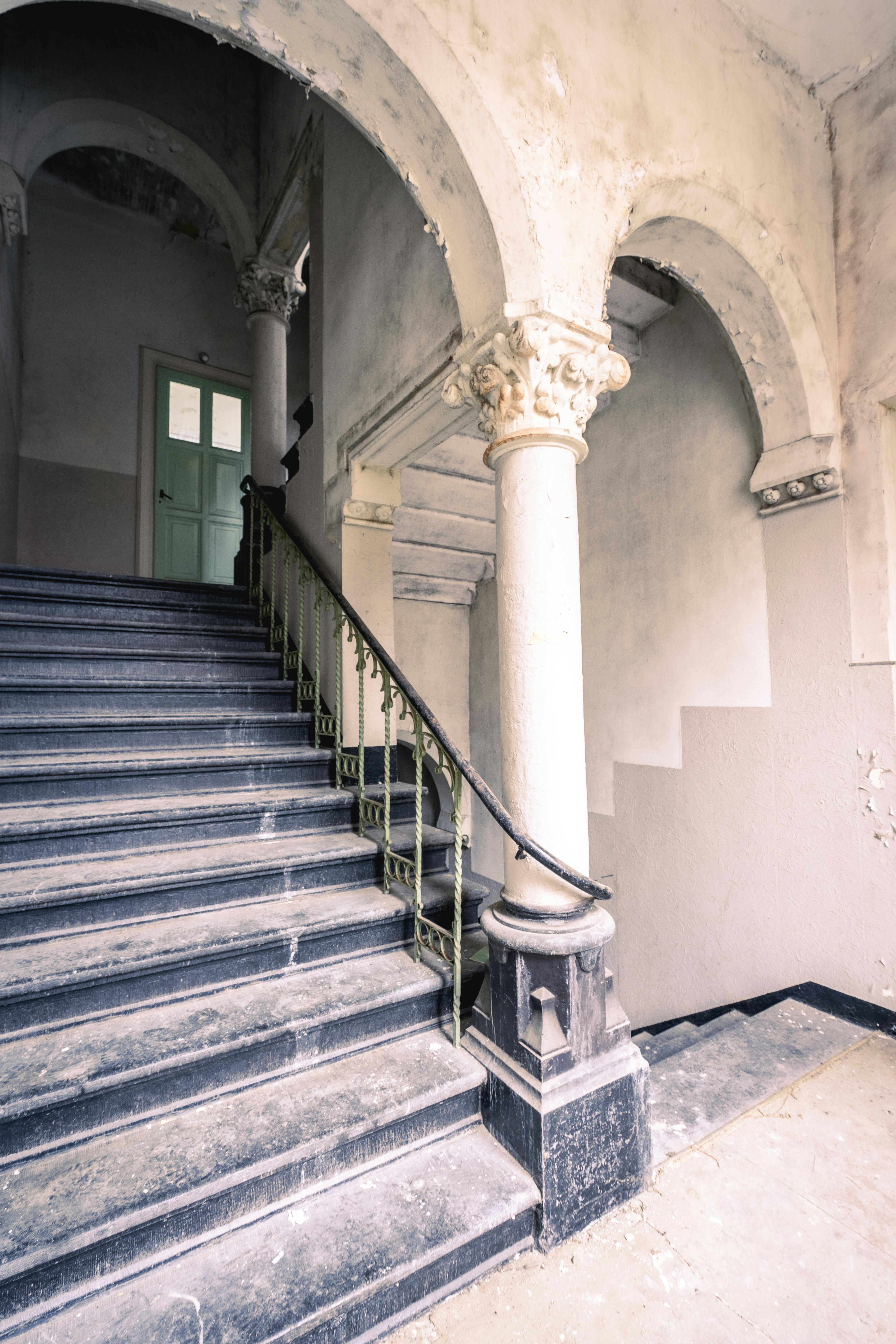 Explore the haunting beauty of this abandoned gothic staircase in an old historical building.