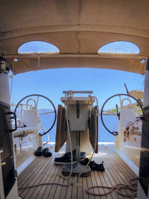 The inside of a boat with a steering wheel and steering wheel