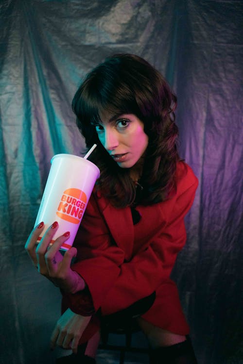 Portrait of Woman with Cup of Beverage from Burger King