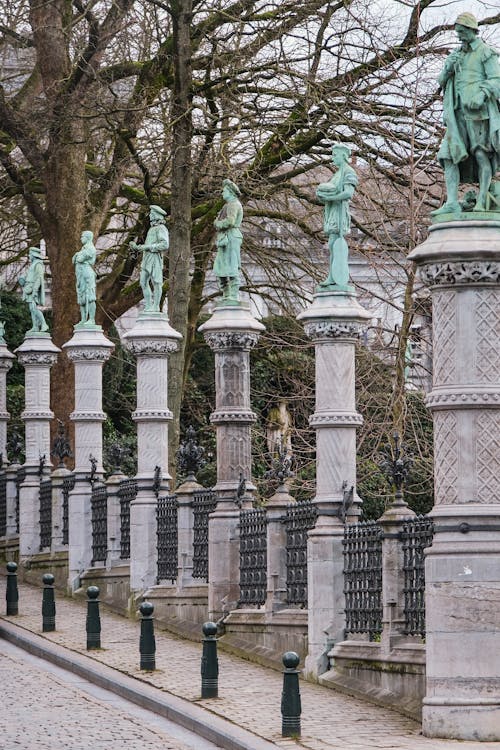 Row of Statues on Pedestals by Street