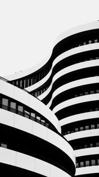 Black and white photo of a modern building with curved architectural design.