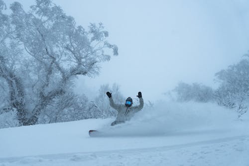 A person snowboarding down a snowy hill