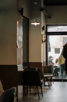 Warm and inviting café setting with stylish chairs and soft lighting, perfect for an urban escape.