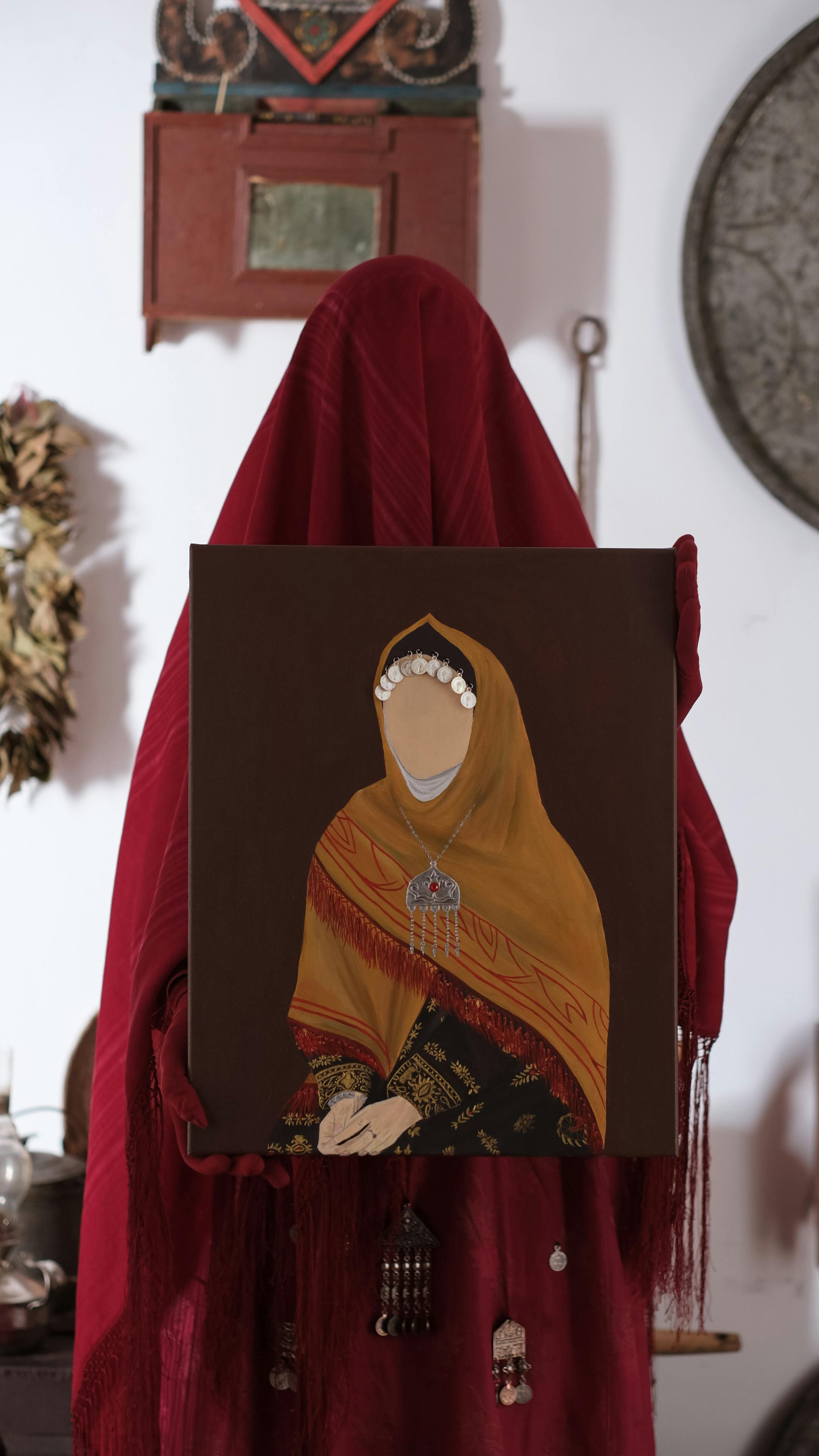 A mysterious portrait with a faceless figure clad in traditional attire.