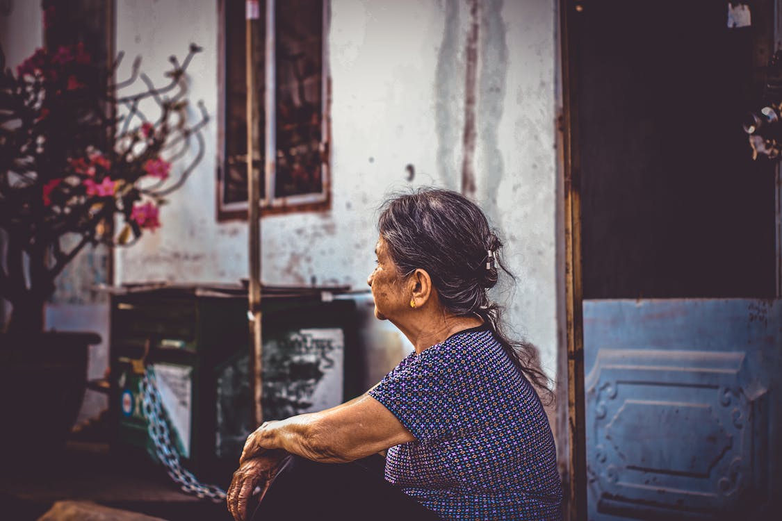 Free Woman Sitting Near Door Stock Photo