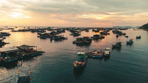 Free Scenic aerial view of fishing boats anchored at sunset near Kiên Giang, Vietnam's coastline. Stock Photo