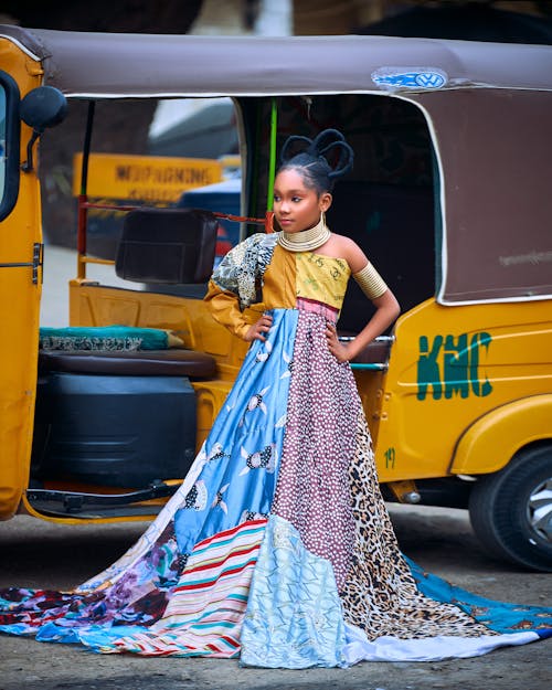 Child Model in Patchwork Dress Posing by Rickshaw