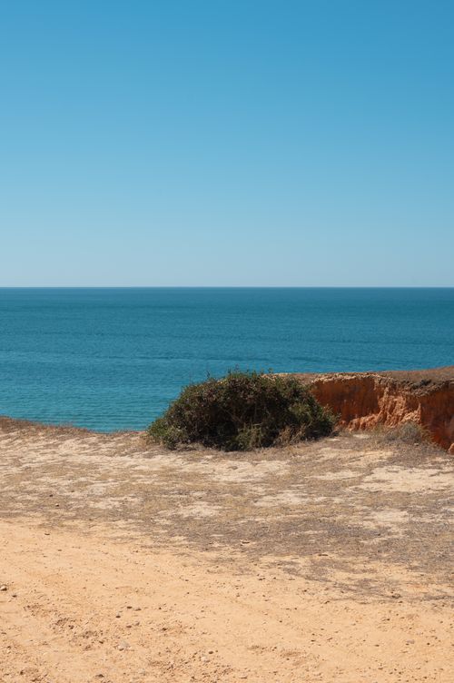 Free Serene ocean view from a cliff in Albufeira, Portugal, under a clear blue sky. Stock Photo