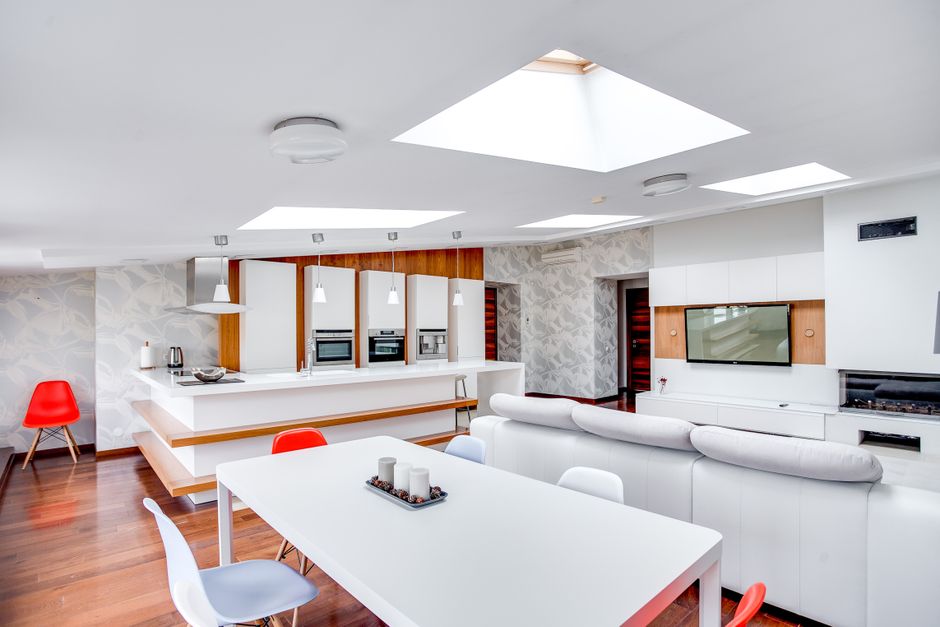 Bright and contemporary apartment space with kitchen island and living area.