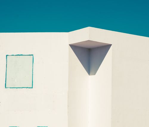 Free Abstract minimalist image of a white building corner against a clear blue sky. Stock Photo