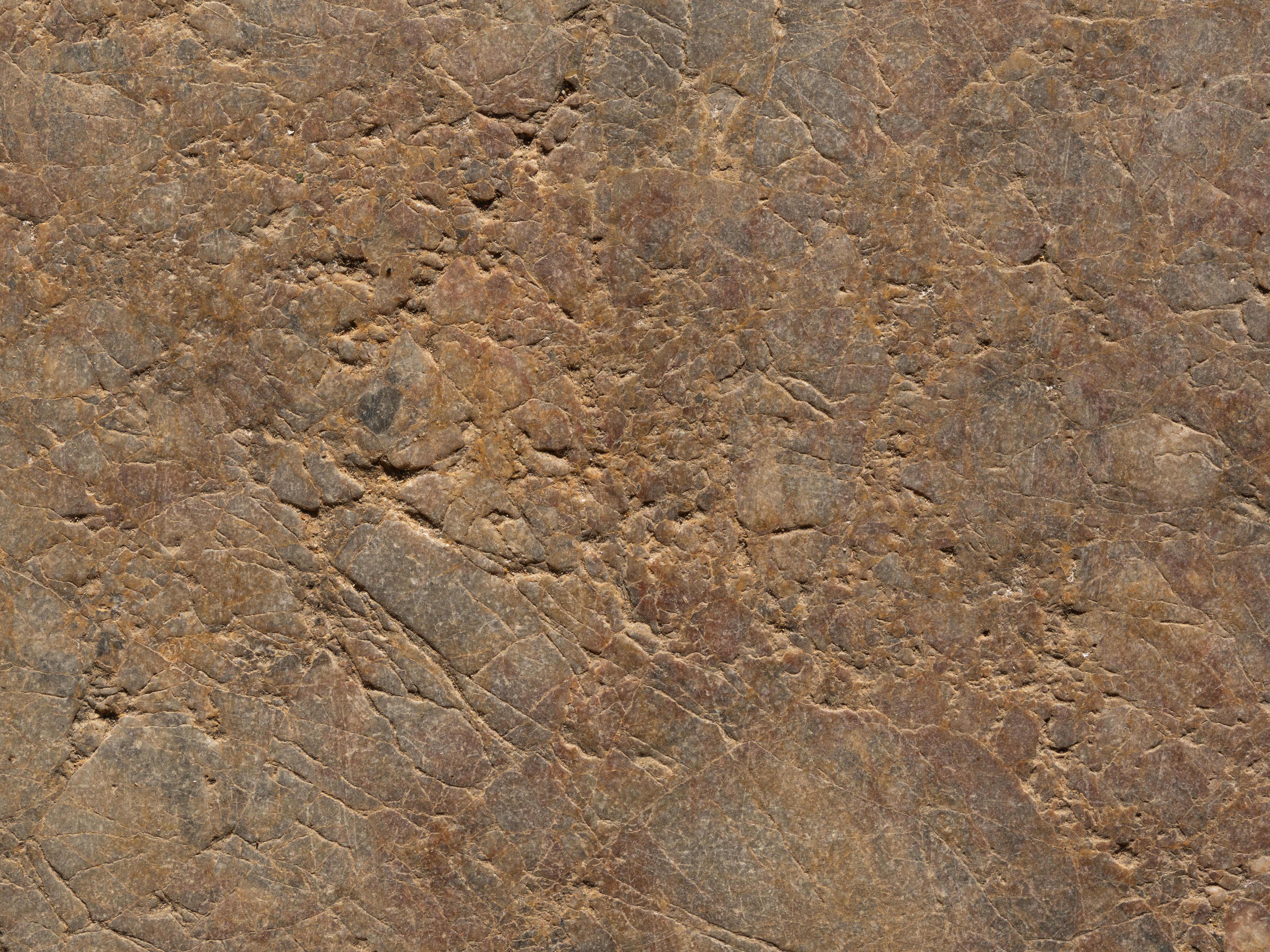 High-resolution image of a rugged stone surface showcasing natural texture and color.