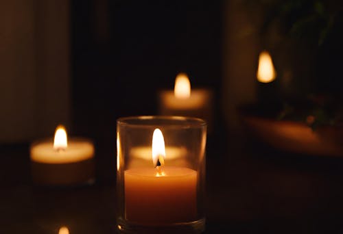 Wax Candles Burning in Darkness