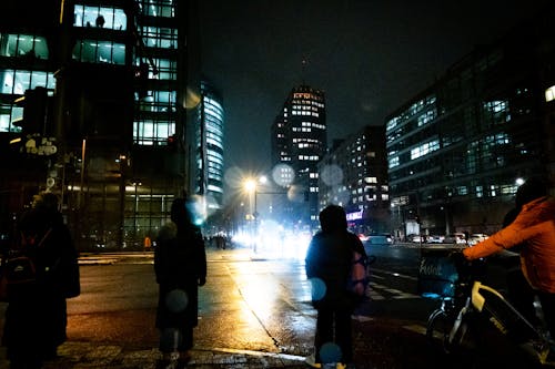 Pedestrians on Street in City at Night