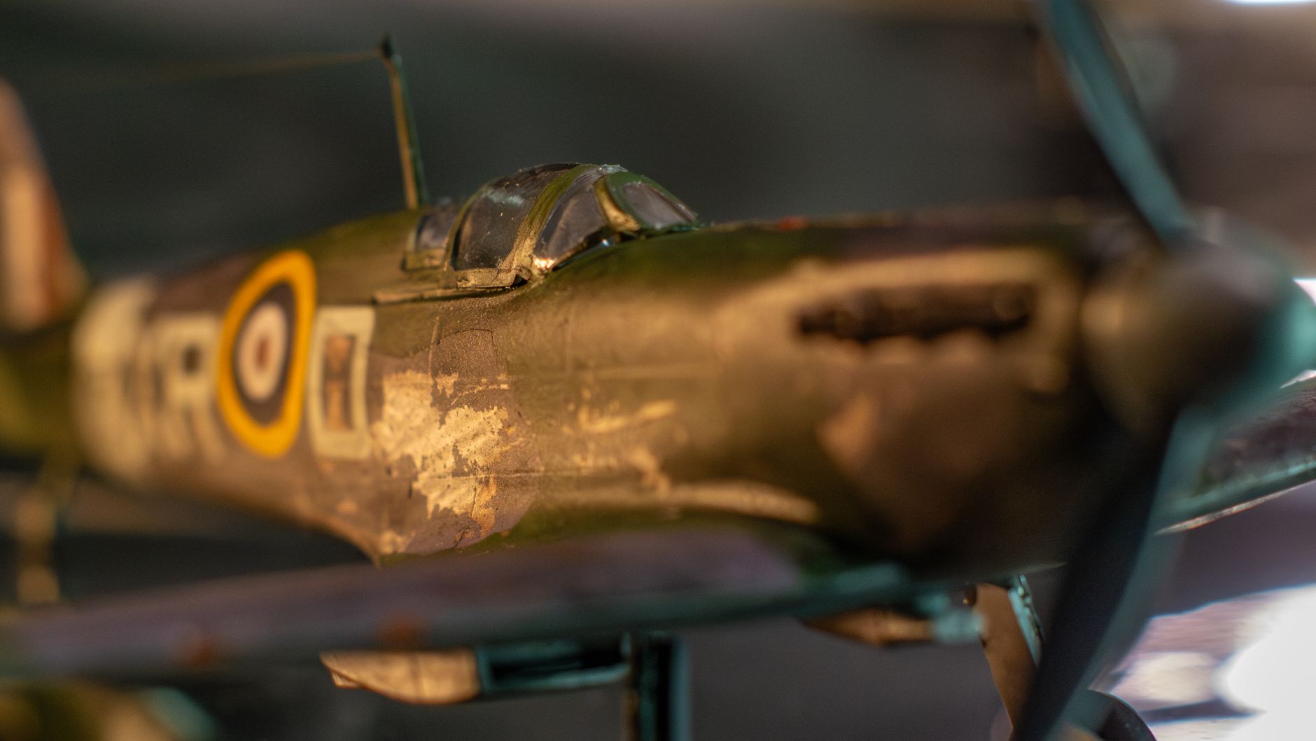 Close-up of a detailed World War II RAF fighter plane model with visible texture and markings.