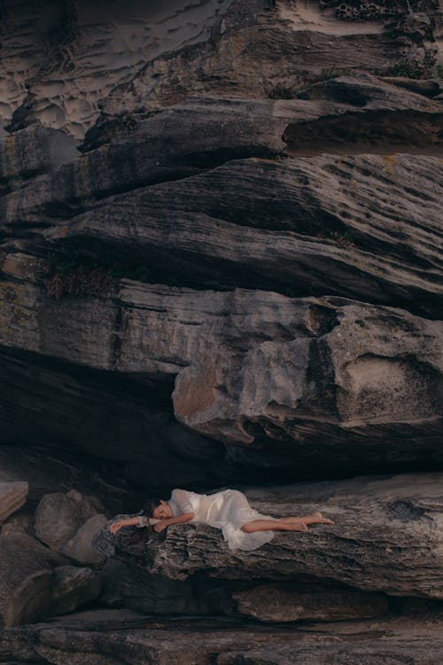 Free Aerial Photography of Woman Lying on Rock Mountain Stock Photo