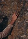 Person Touching Rock