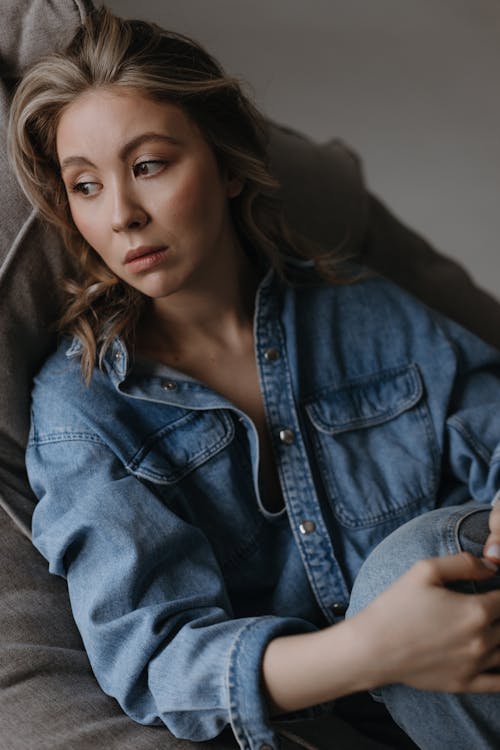 Pensive Woman in Denim Jacket and Jeans