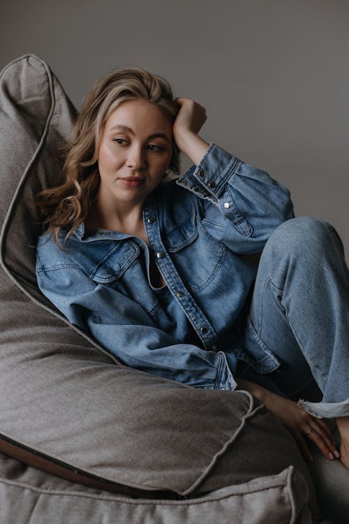 Woman Sitting in a Gray Armchair