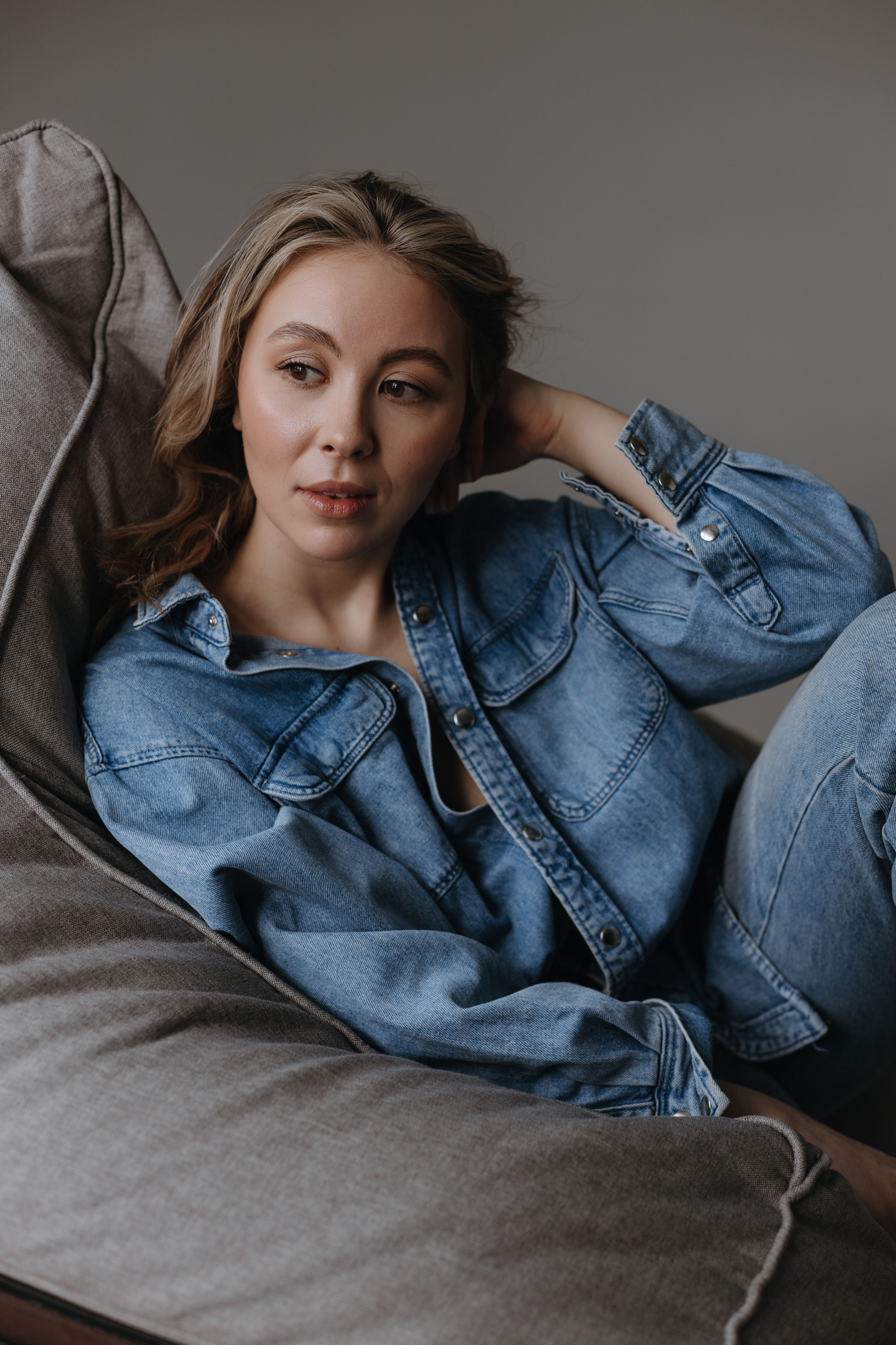 Woman in Denim Jacket Sitting on a Bean Bag Chair · Free Stock Photo