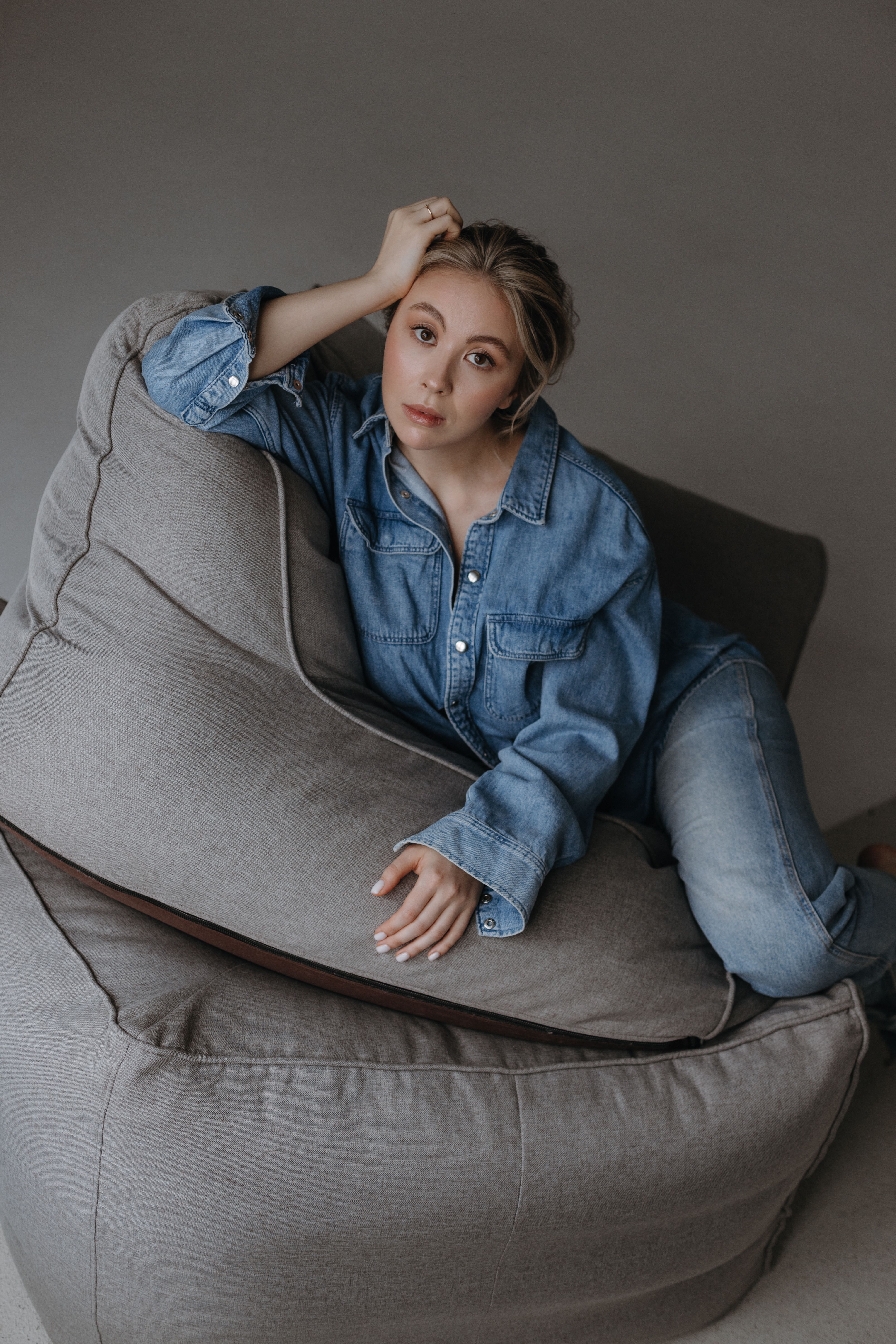 Woman Lying on Gray Bean Bag Chair · Free Stock Photo