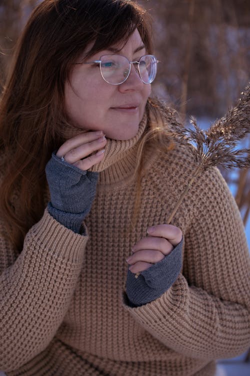 Woman in a Brown Knitted Sweater on a Snow-covered Glade