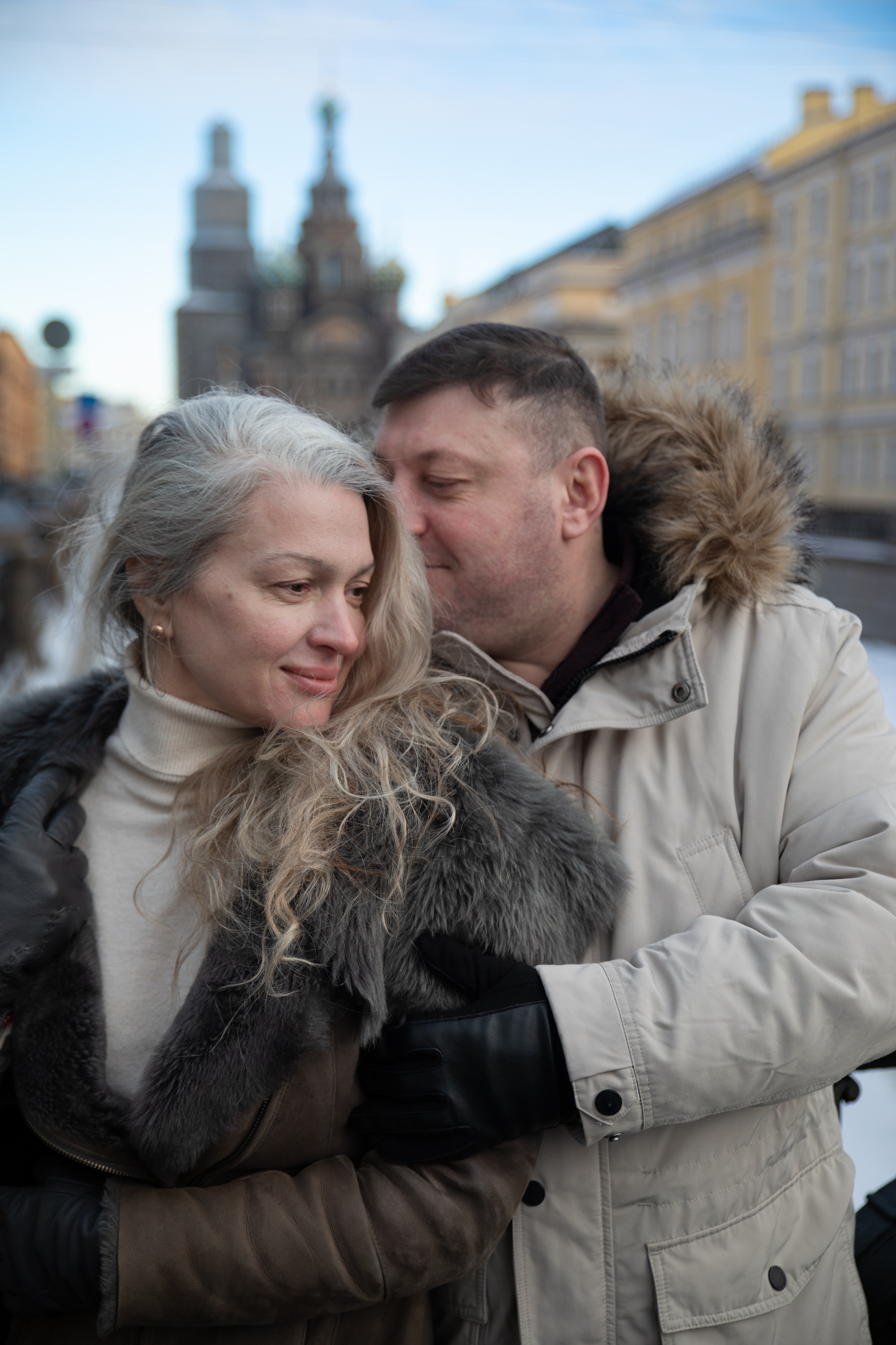 People aged 40 to 65 in front of a residential building in France