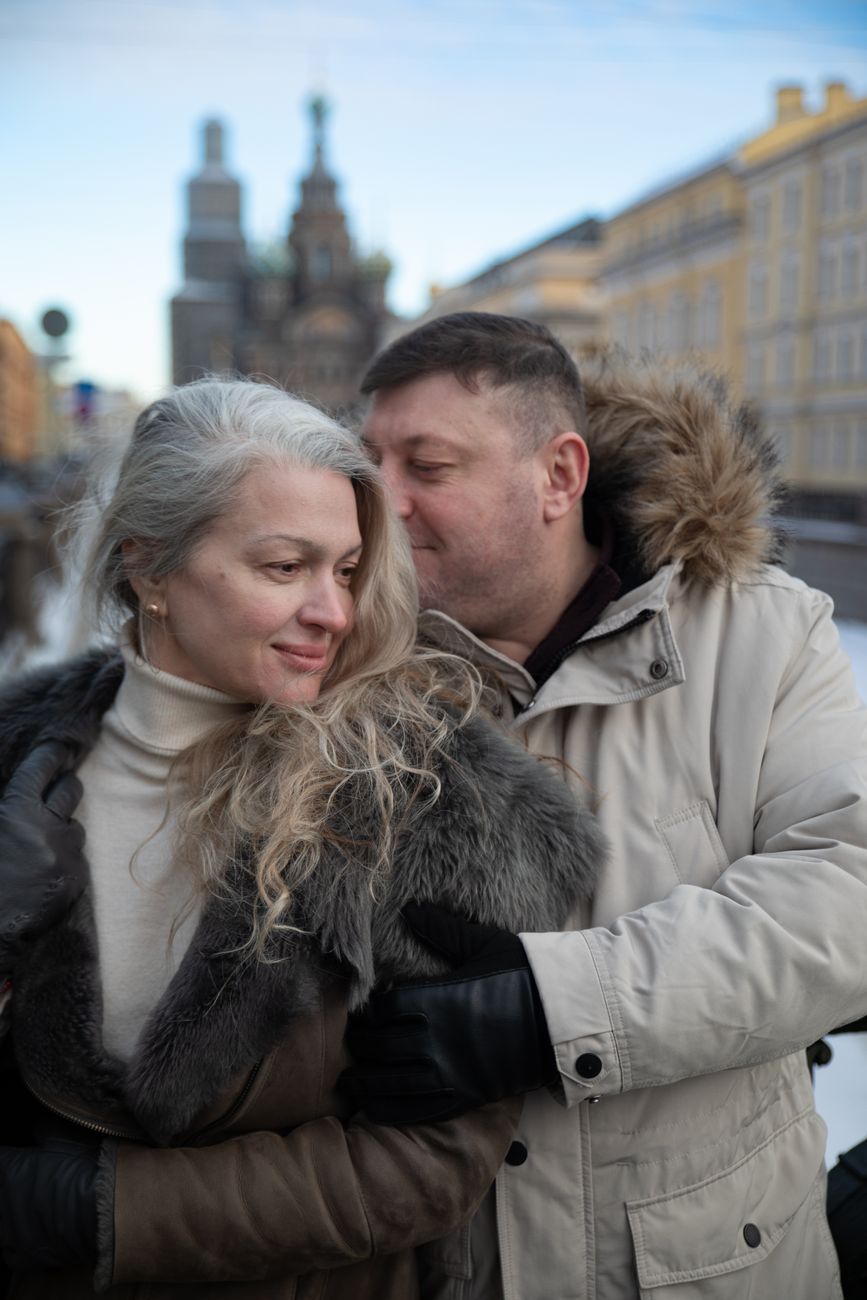 People aged 40 to 65 in front of a residential building in France