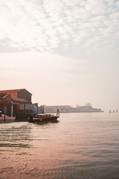 Free Peaceful morning view of boats moored at a bay with soft sunrise colors and calm sea. Stock Photo