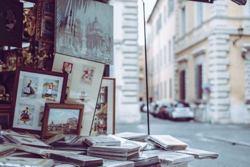 Free Framed art and pictures displayed at a street market in Rome, capturing the city's vibrant outdoor shopping scene. Stock Photo
